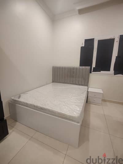 bed with mattress and beside table