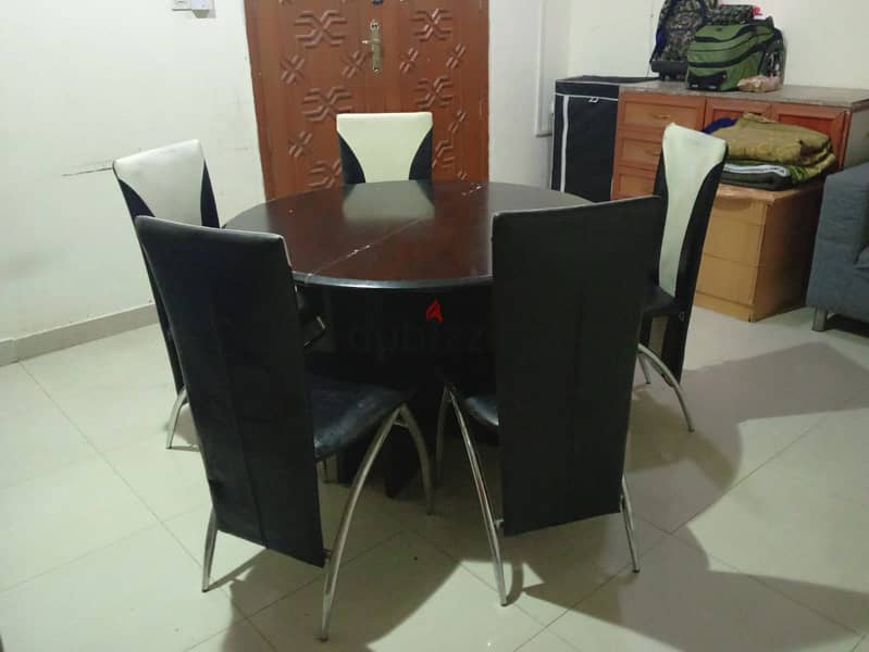 Round Black dinning Table with five chairs. 1